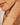 Close-up of a woman's arm wearing a delicate bracelet with white gemstones.