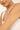Woman holding a delicate pearl bracelet on a plain background