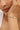 Close-up of a woman's arm wearing a bracelet with pearls and gemstones.