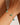 Bracelet with green beads on a wrist against a neutral background