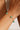 Bracelet with green beads on a wrist against a neutral background