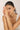 Woman with a pearl bracelet on a plain background
