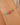 Gold bracelet with pink and green beads on a wrist