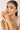 Woman wearing a pearl bracelet on a plain background