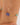 Gold bracelet with a blue and green bead on a wrist against a neutral background