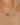 Gold chain necklace with a gemstone on a blurred background