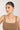 Woman wearing a necklace against a plain background