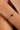 Gold bracelet with blue stones on a wrist against a neutral background
