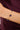 Gold bracelet with blue stones on a wrist against a dark background
