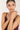 Woman wearing a bracelet on a plain background