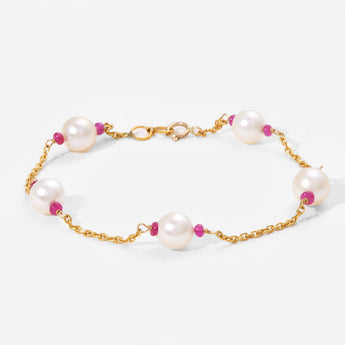 Pearl bracelet with gold chain and pink beads on a white background
