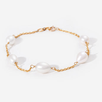 Pearl bracelet with gold chain on a white background
