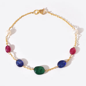Gold bracelet with colorful gemstones on a white background