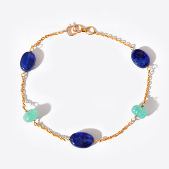 Bracelet with blue and green beads on a white background