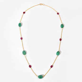 Necklace with green and red beads on a white background