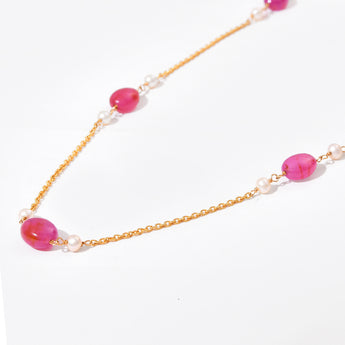 Necklace with pink beads and gold chain on a white background