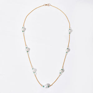 Pearl necklace with gold chain on a white background