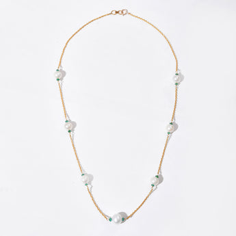 Pearl necklace with gold chain on a white background