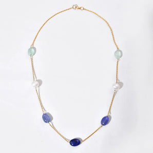 Necklace with purple and white beads on a white background