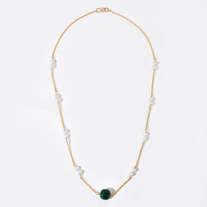 Necklace with green bead and pearls on a white background