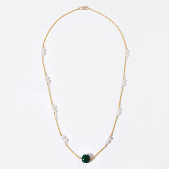 Necklace with green bead and pearls on a white background