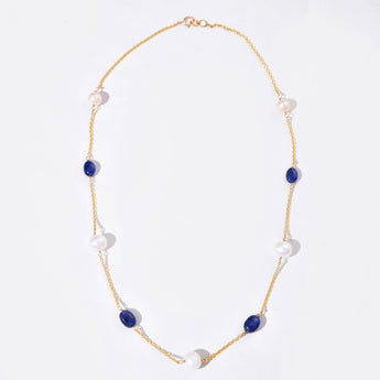 Necklace with blue and white beads on a white background