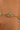 Gold chain bracelet with clear gemstones on a person's wrist