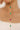 Gold chain necklace with green and pink beads on a blurred background