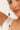Close-up of a bracelet with green and white beads against a blurred background