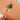Gold bracelet with green stone and pearls on a wrist against a neutral background