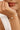 Pearl bracelet on a wrist with a neutral background