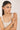 Woman wearing a beige tank top against a plain background