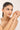 Woman wearing a bracelet on a plain background