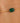Gold bracelet with a green gemstone on a person's wrist
