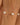 Gold bracelet with pearls on a wrist against a neutral background