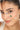 Close-up of a woman's face with delicate bracelet on her face