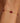 Gold bracelet with red beads on a wrist against a blurred background