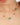 Necklace with green and red beads on a person's neck