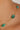 Gold necklace with green beads on a woman's neck
