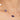 Gold necklace with purple gemstones and a pearl on a woman's neck