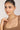 Woman wearing a necklace against a plain background