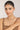 Woman wearing a necklace against a plain background