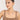 Woman wearing a necklace against a plain background