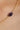 Gold chain necklace with a blue stone on a woman's neck