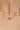 Necklace with pearls and a pink gemstone on a woman's neck