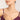 Woman wearing a pearl necklace with a plain background