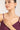 Woman wearing a pearl necklace with a plain background