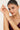 Woman wearing a bracelet on her wrist with a plain background