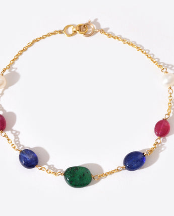 Gold bracelet with colorful gemstones on a white background