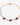 Gold bracelet with red gemstones and white pearls on a white background